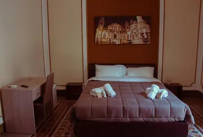 a bedroom with a bed with two pillows on it at Mizzica Rooms in Palermo