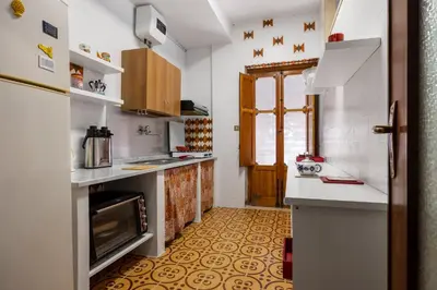 a kitchen with a sink and a stove at Casa Eugenia in Santa Flavia