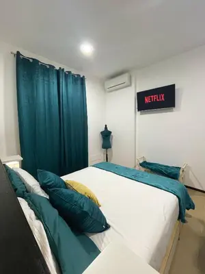 a hospital room with a bed with blue curtains at La casa di Alice in Palermo