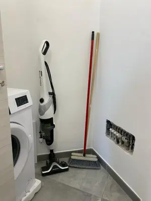 a room with a mop and a washing machine at San Vito Holiday Home in San Vito lo Capo