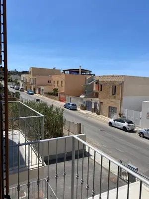a view of a street with cars parked on the road at San Vito Holiday Home in San Vito lo Capo