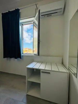 a room with a desk and a window at Sirio rooms and apartments in Carini