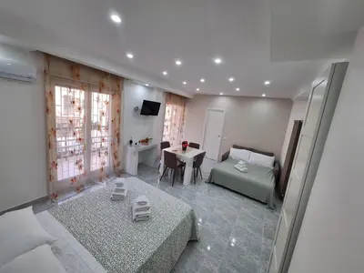 a living room with a bed and a table at Casa cannella in Palermo