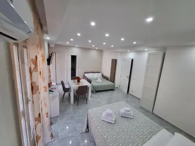 a living room with a table and a couch at Casa cannella in Palermo