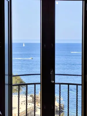 a room with a view of the ocean from a balcony at Open Space Marianna - Sea View in Trabia