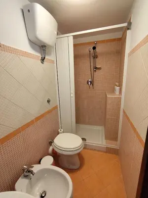 a bathroom with a toilet and a shower and a sink at Open Space Marianna - Sea View in Trabia