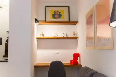 a living room with wooden shelves and a couch at Resuttano Loft in Palermo