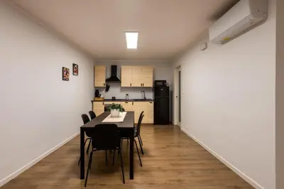 a kitchen and dining room with a table and chairs at Villareale Flat - Palermo City Center Free Parking in Palermo