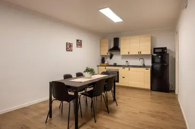 a kitchen and dining room with a table and chairs at Villareale Flat - Palermo City Center Free Parking in Palermo