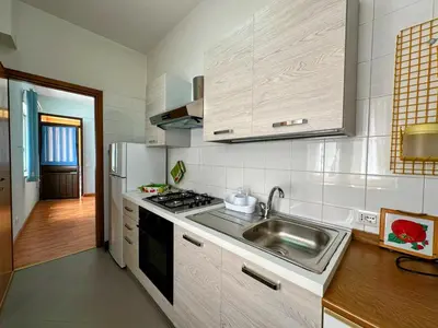 a kitchen with a sink and a stove top oven at Balestrate Mare Centro Wi-Fi Self Check-in Aria Condizionata in Balestrate