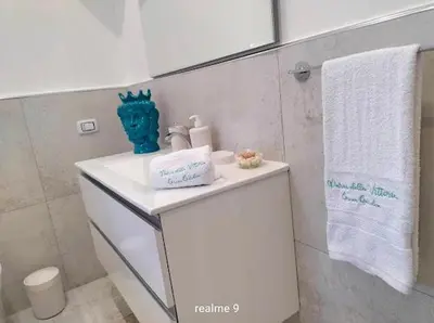 a bathroom with a white sink and a white towel at Parco della Vittoria in Terrasini