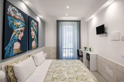 an outdoor patio with yellow tables and chairs at Casa Azzurra Rooms e apartment in Terrasini