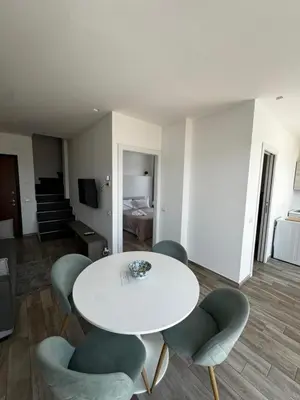 a living room with a white table and chairs at Marina Rooftop Exclusive View in Palermo
