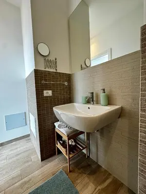 a bathroom with a sink and a mirror at Marina Rooftop Exclusive View in Palermo