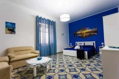 a living room with a bed and a couch at Pegaso 15 Home in Palermo