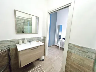 a bathroom with a sink and a mirror at Domus Livi in Cinisi