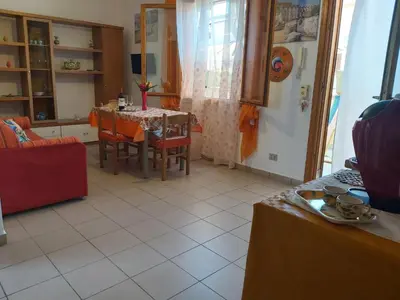 a kitchen and dining room with a table and chairs at Casa Cinque Torri in San Vito lo Capo