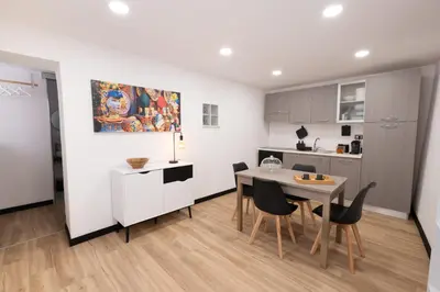 a kitchen and dining room with a table and chairs at aprimaManu apartment in Monreale