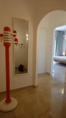 a room with a mirror and a red pole at Appartamento Strasburgo in Palermo