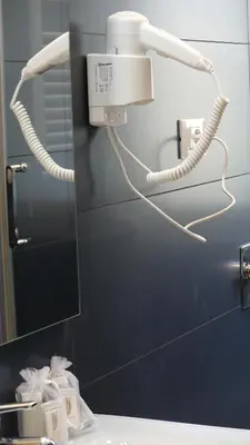 a bathroom with a mirror and a light on the wall at Appartamento Strasburgo in Palermo