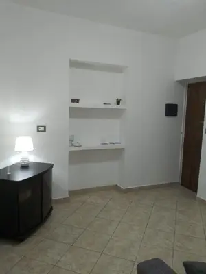 a room with a table and shelves on the wall at Mo MA in Palermo