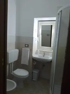 a bathroom with a toilet and a sink and a mirror at Mo MA in Palermo
