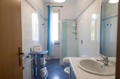a bathroom with a sink and a toilet and a shower at VillaThomas in Campofelice di Roccella