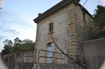 a building on a wall with a fence at Tenuta Rapillo in Castellammare del Golfo