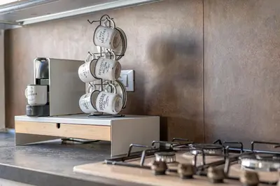 a pile of coffee mugs stacked on top of a stove at Dasaro in Palermo