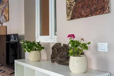 two white vases with flowers on top of a table at Dasaro in Palermo