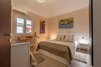a bedroom with a bed and a desk and a window at Dasaro in Palermo
