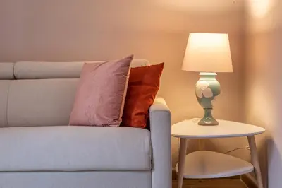 a lamp on a side table next to a couch at Dasaro in Palermo