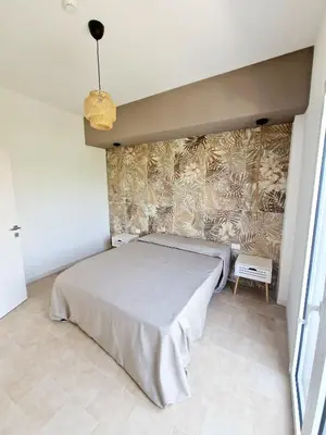 a bedroom with a bed and a wall at Castellammare Riviera in Alcamo Marina