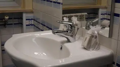 a bathroom sink with a soap dispenser on it at AppartamentoBelgio in Palermo