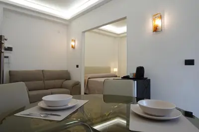 a living room with a glass table with two bowls on it at AppartamentoBelgio in Palermo