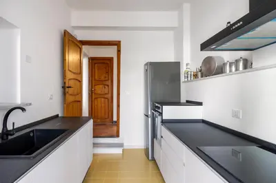 a kitchen with black counter tops and a sink at La Veranda Sul Mare in Santa Flavia