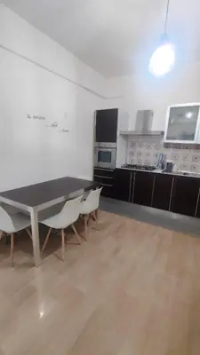 a kitchen with a table and chairs in a room at Villa Triscele Holiday Home in Partinico