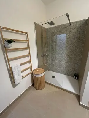 a bathroom with a shower with a toilet and a stool at Villa Triscele Holiday Home in Partinico