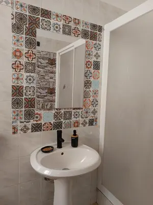 a bathroom with a white sink and a mirror at B&B a casa di Peppe in Palermo