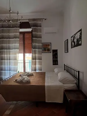 a bedroom with a large bed with a window at B&B a casa di Peppe in Palermo