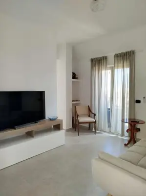 a living room with a television and a couch at 7 floor in Palermo