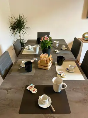 a table with cups and plates and flowers on it at Zagara in Palermo