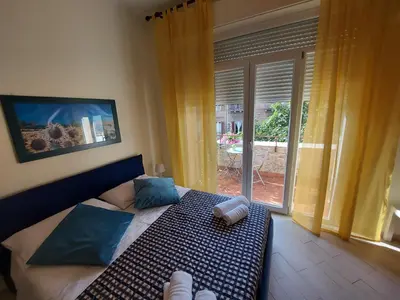 a bedroom with a bed and a large window at Teatro Massimo - Apartment with Private Balcony in Palermo