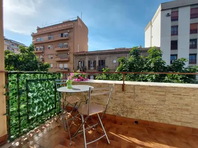 a balcony with a table and two chairs on it at Teatro Massimo - Apartment with Private Balcony in Palermo