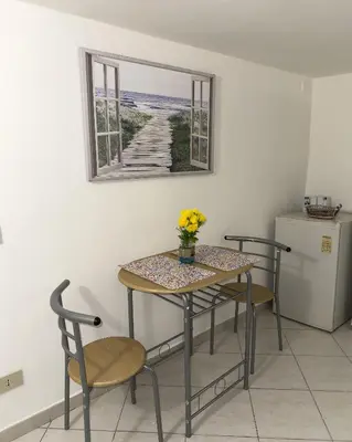 a table and chairs with a table and a window at politeama guest house il rifugio Palermo in Palermo