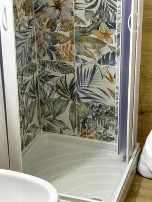 a bathroom with a shower with a tile wall at politeama guest house il rifugio Palermo in Palermo