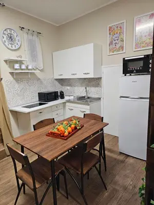 a kitchen with a table with fruits and vegetables on it at RC SUITE Annunziata in Termini Imerese