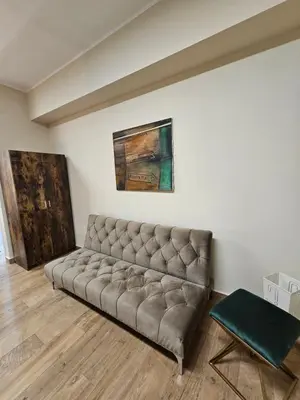 a couch in a room with a painting on the wall at RC SUITE Annunziata in Termini Imerese