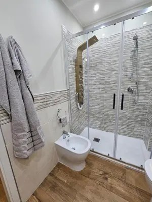 a bathroom with a shower and a toilet and a sink at RC SUITE Annunziata in Termini Imerese