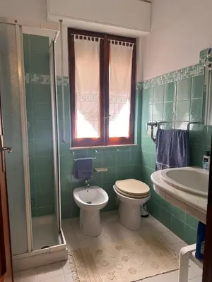 a bathroom with a toilet and a sink and a shower at Casa Letizia in Alcamo